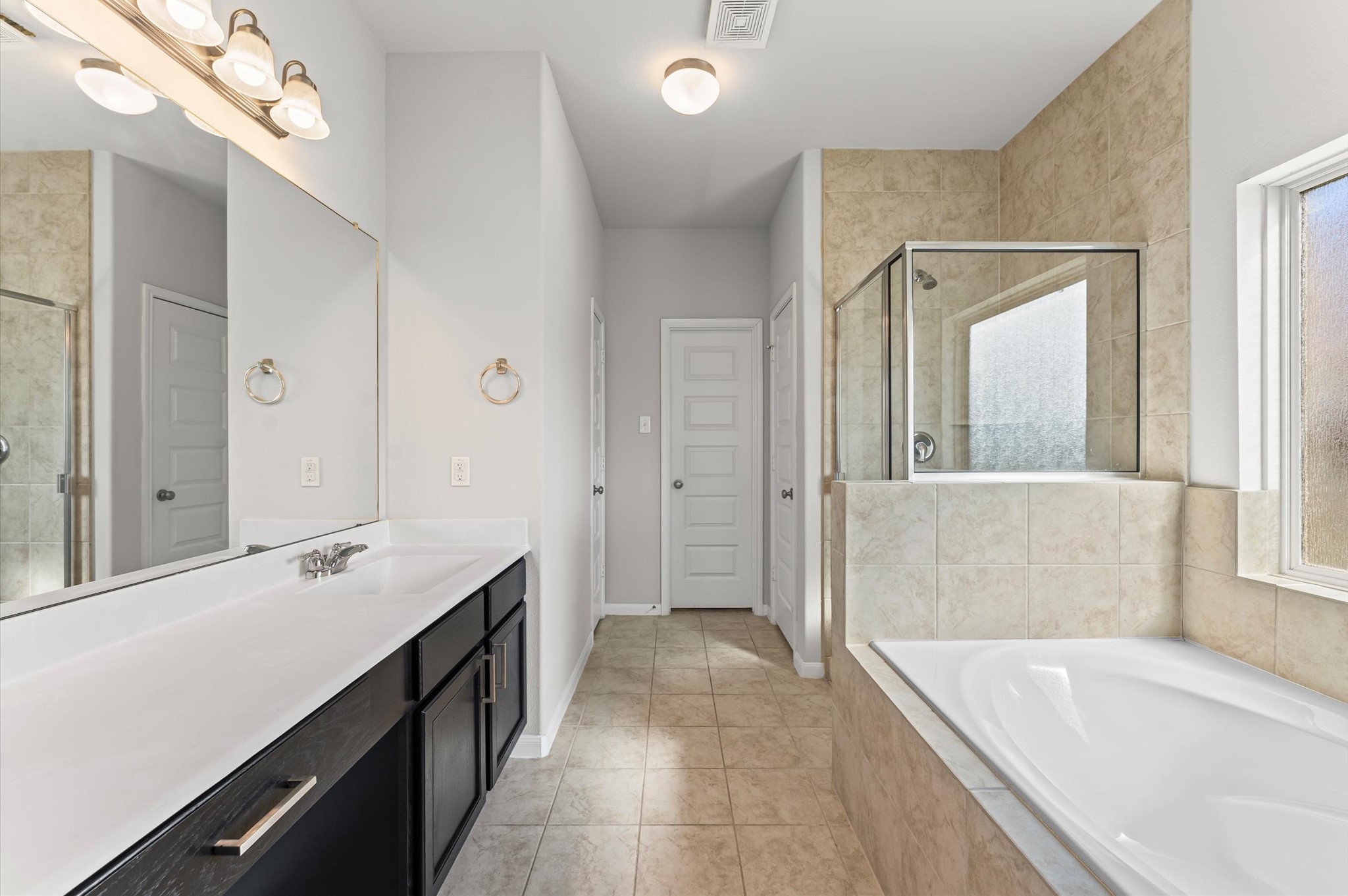 15207 Lake Erie Drive Humble, TX 77396 - Photo 16 of 37 a bathroom with a tub a sink and a mirror