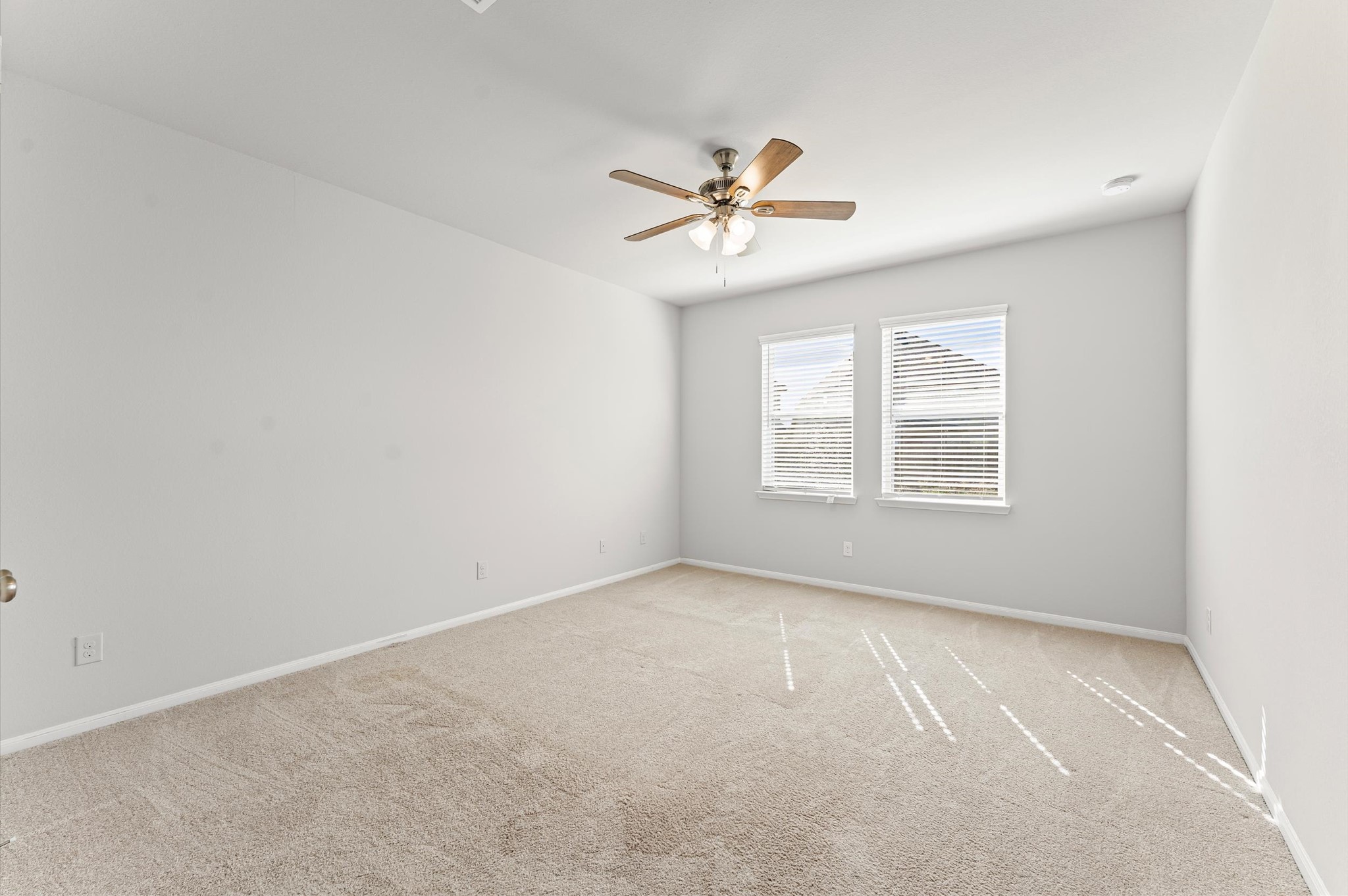 15207 Lake Erie Drive Humble, TX 77396 - Photo 18 of 37 an empty room with windows and fan