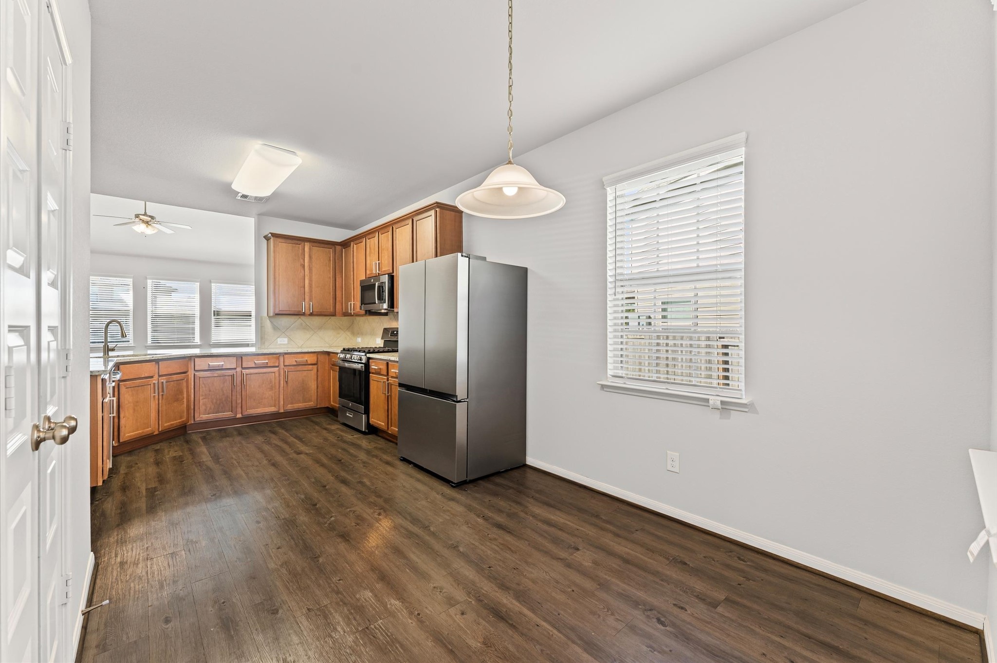 15207 Lake Erie Drive Humble, TX 77396 - Photo 7 of 37 a kitchen with stainless steel appliances a refrigerator sink and microwave