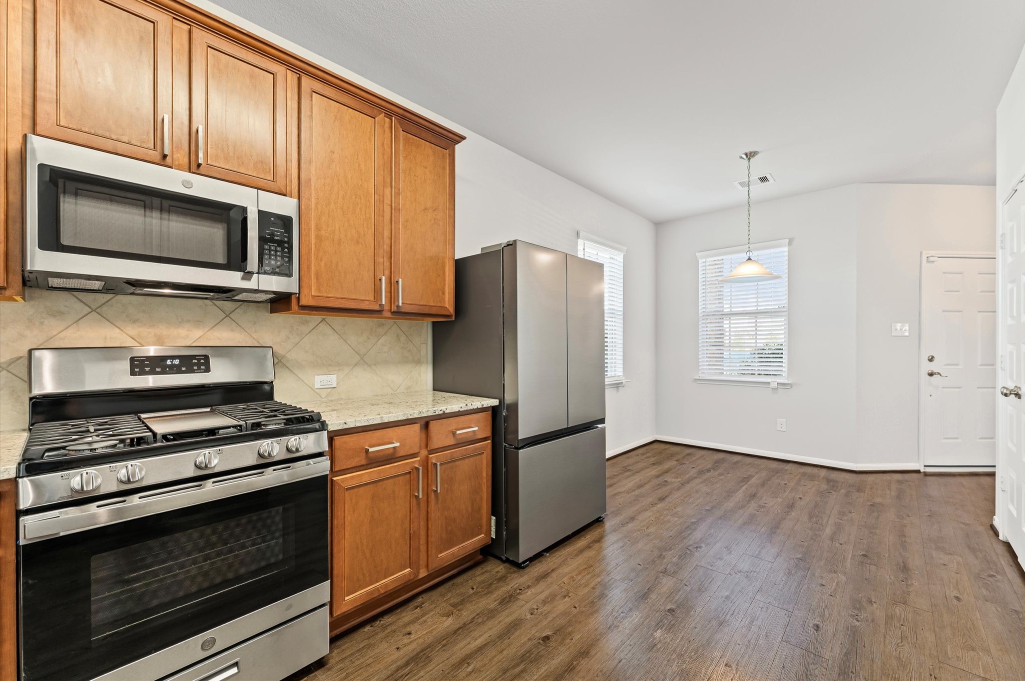 15207 Lake Erie Drive Humble, TX 77396 - Photo 8 of 37 a kitchen with stainless steel appliances granite countertop a stove microwave and refrigerator