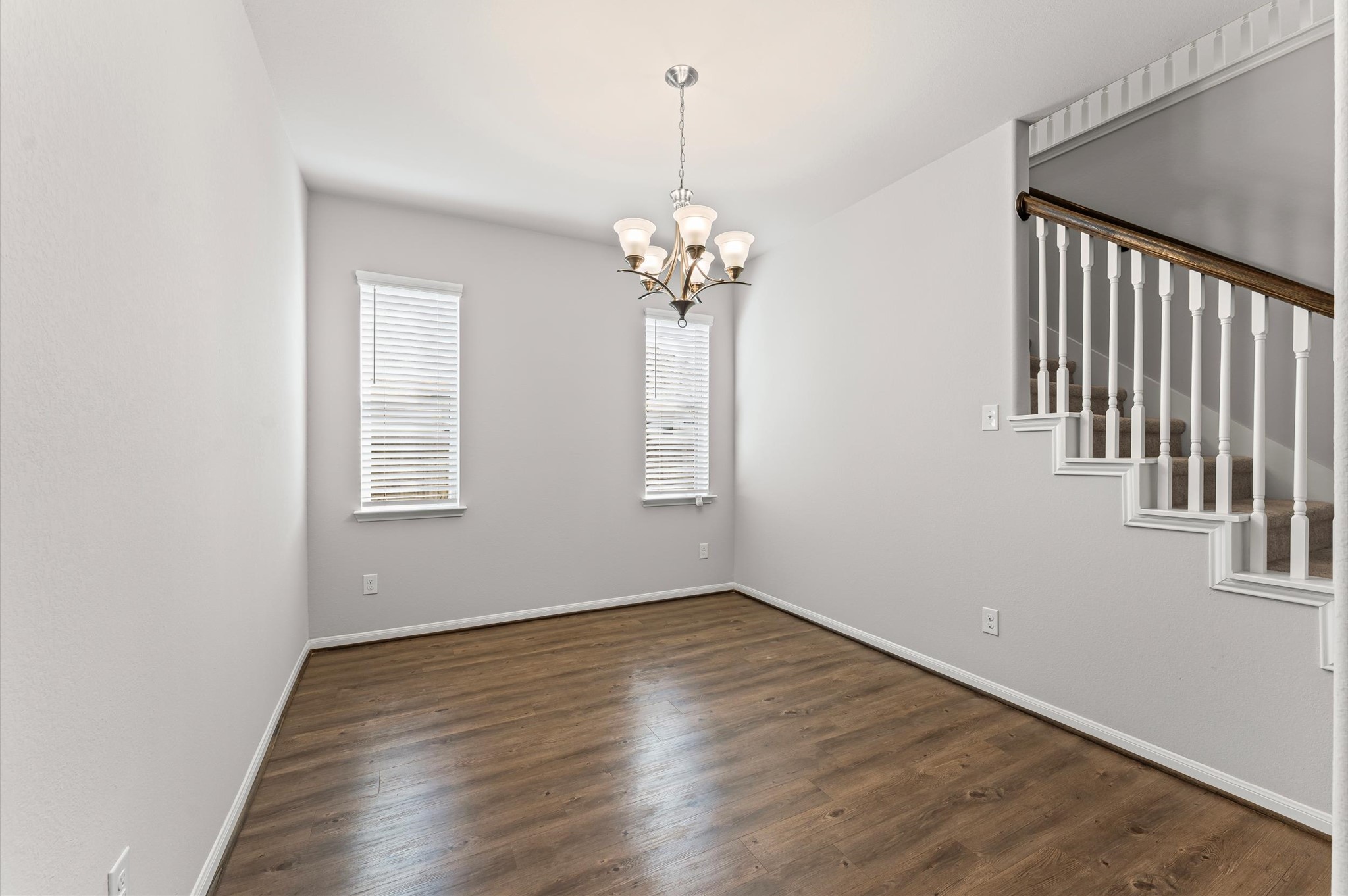 15207 Lake Erie Drive Humble, TX 77396 - Photo 10 of 37 a view of a hallway with wooden floor and a chandelier