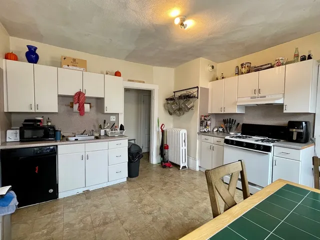 a kitchen with stainless steel appliances a stove refrigerator sink and cabinets