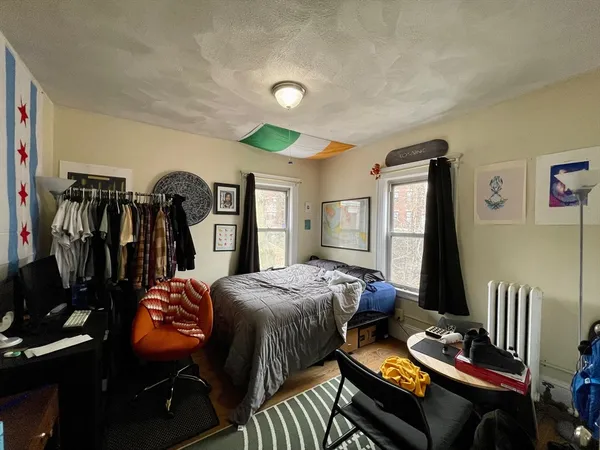 a bedroom with bed and a window