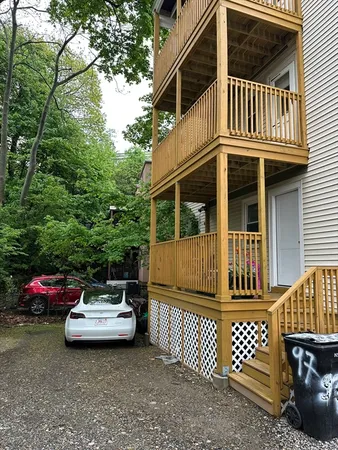 a view of a patio with a table and chairs and wooden fence