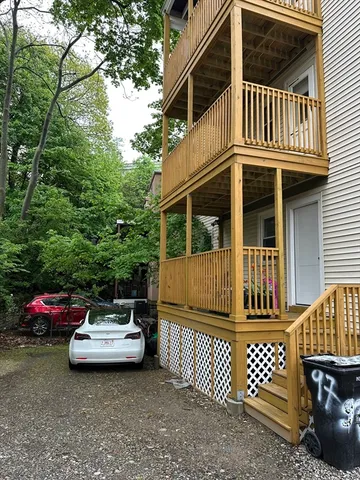 a view of a patio with a table and chairs and wooden fence