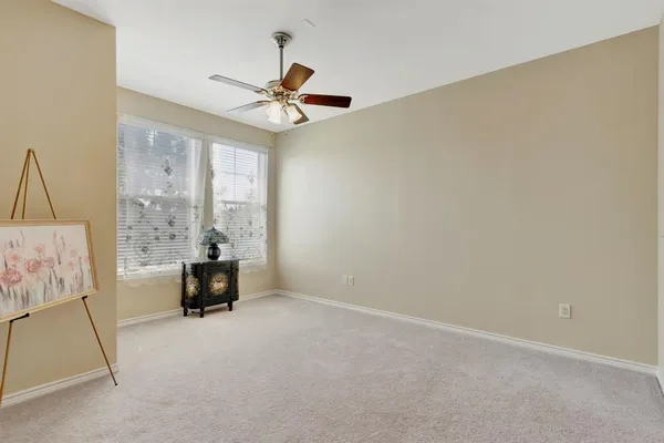 a view of room with window and ceiling fan