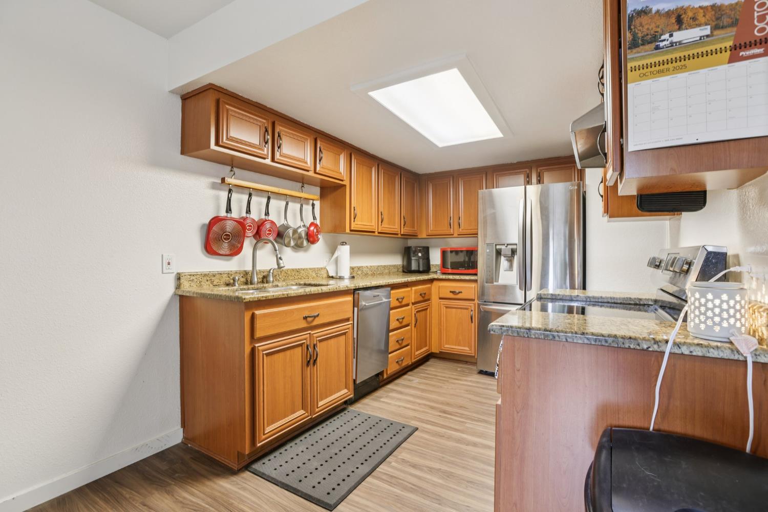 3700 Tully Road, Unit 57 Modesto, CA 95356 - Photo 11 of 34 a kitchen with stainless steel appliances granite countertop a sink stove and cabinets