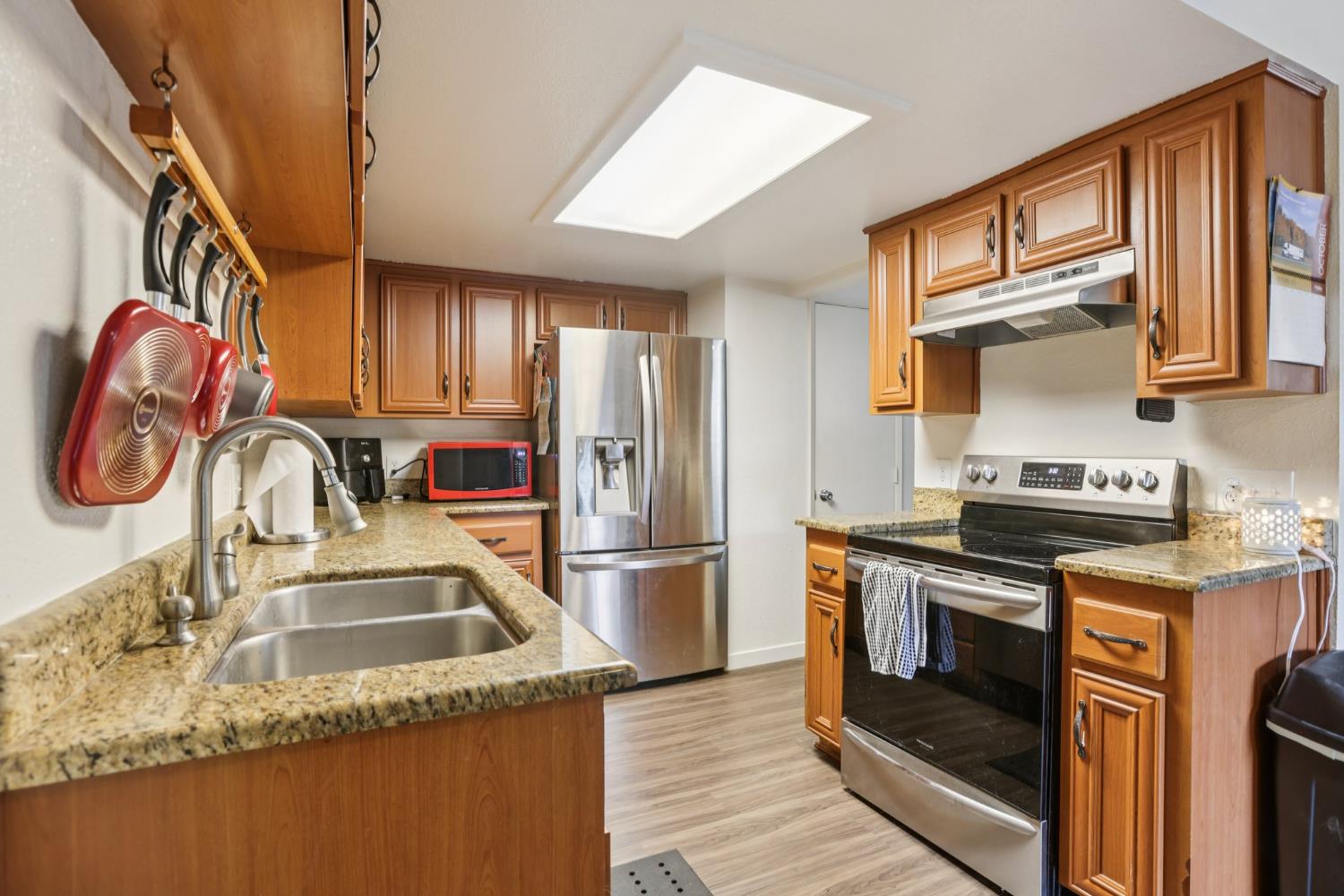 3700 Tully Road, Unit 57 Modesto, CA 95356 - Photo 12 of 34 a kitchen with granite countertop a sink stainless steel appliances and cabinets