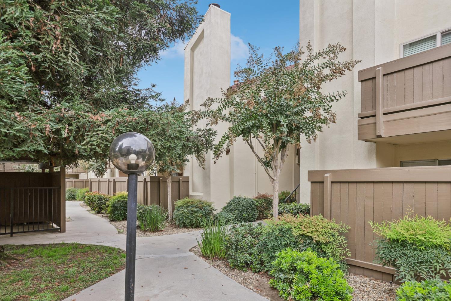3700 Tully Road, Unit 57 Modesto, CA 95356 - Photo 2 of 34 a front view of a house with a yard and tree s