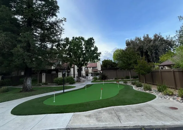 a swimming pool with outdoor seating and yard