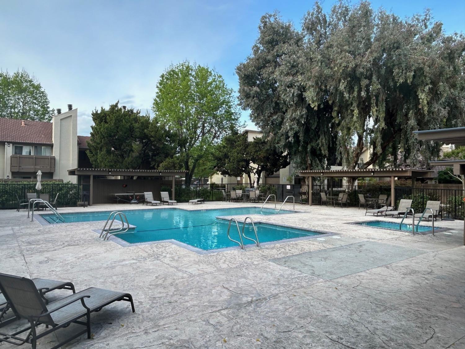 3700 Tully Road, Unit 57 Modesto, CA 95356 - Photo 29 of 34 a swimming pool with outdoor seating and yard