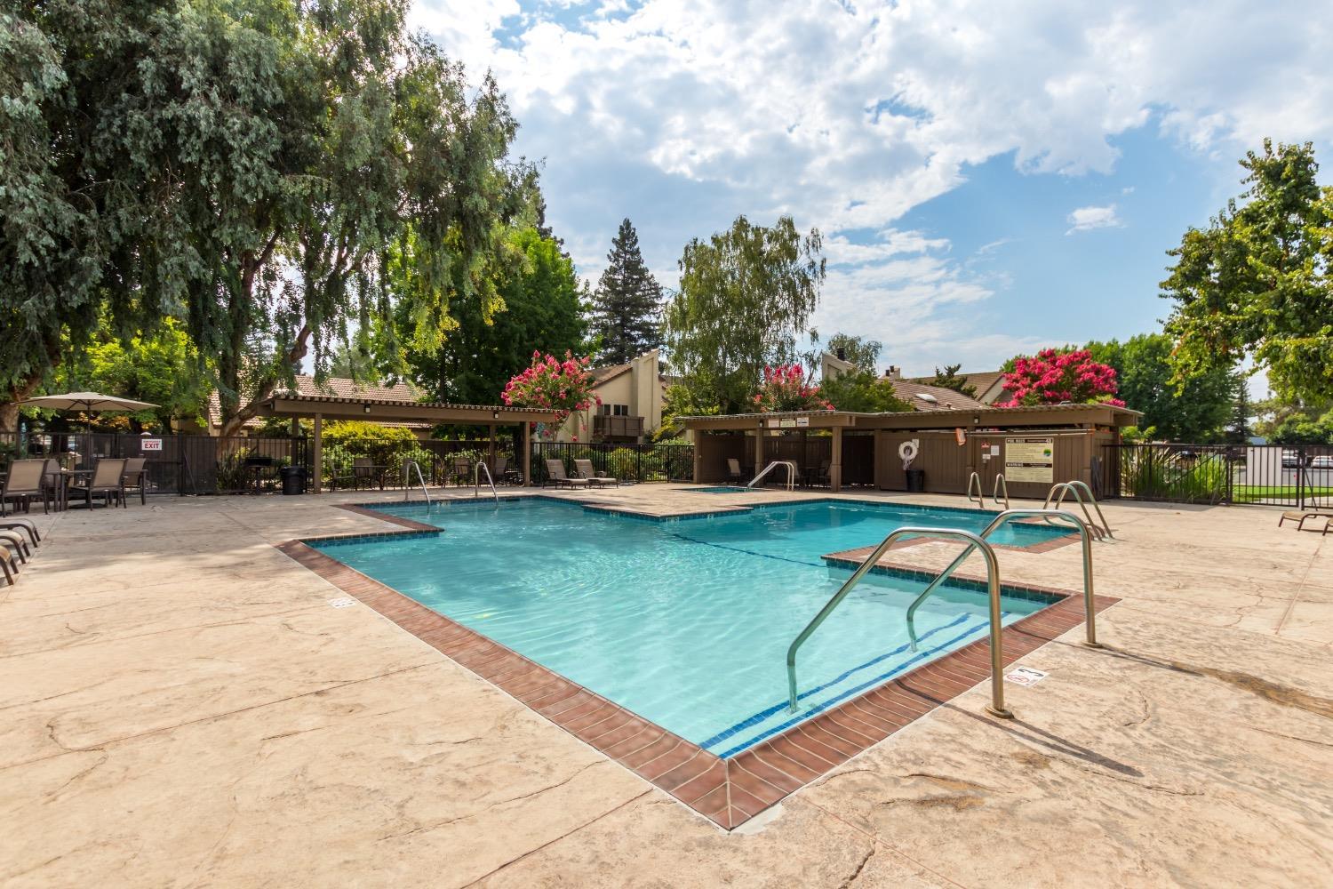 3700 Tully Road, Unit 57 Modesto, CA 95356 - Photo 30 of 34 a view of a swimming pool with a bench and trees