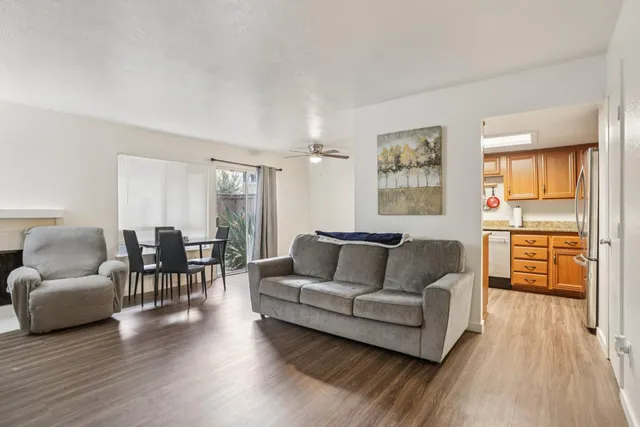 a living room with furniture and a wooden floor