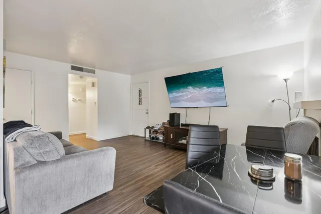 a work room with furniture and a flat screen tv