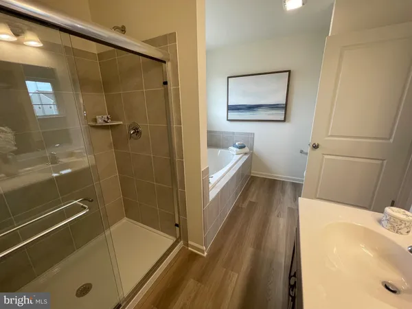 a bath tub sitting next to a white sink