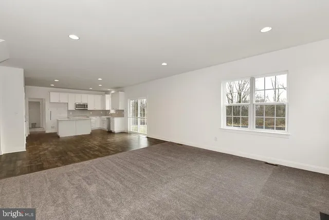 a bathroom with a sink double vanity granite tub and a mirror