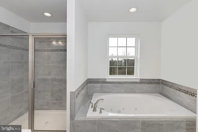 a bathroom with a sink vanity mirror and shower