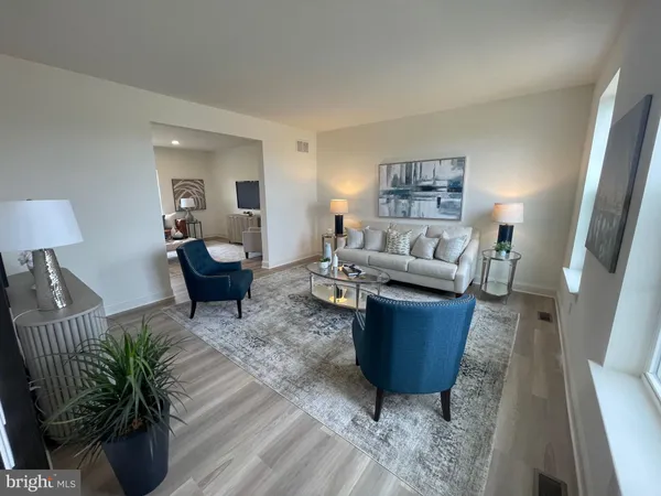 a living room with furniture wooden floor and window