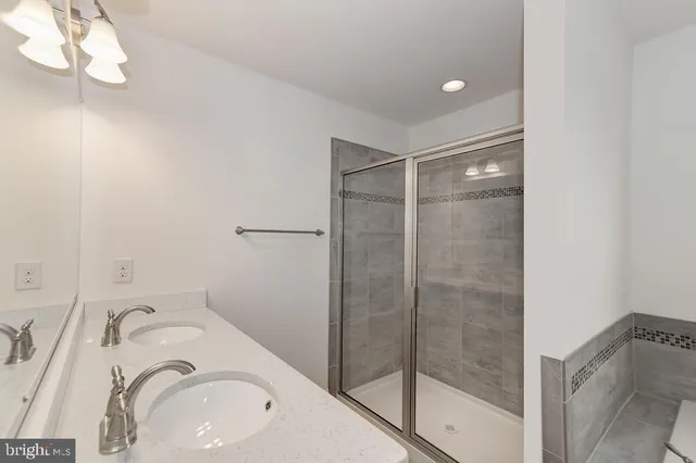 a kitchen with stainless steel appliances granite countertop a sink counter space and wooden floor