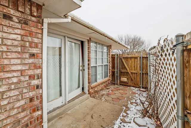 a front view of a house with wooden fence