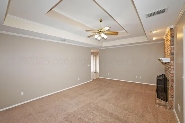 an empty room with windows and ceiling fan