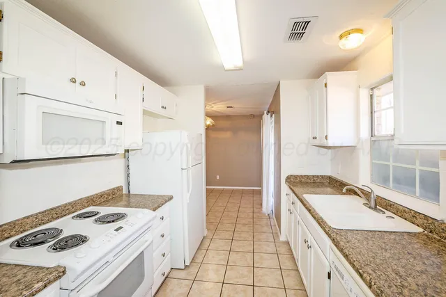 a kitchen with a sink stove and refrigerator