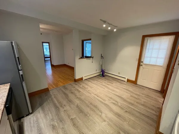 a view of a livingroom with wooden floor and stairs