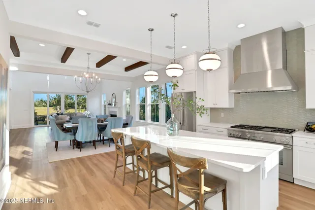 a living room with furniture a fireplace and a large window