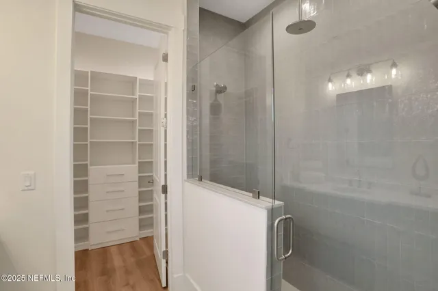 a view of a balcony with wooden floor and a ocean view