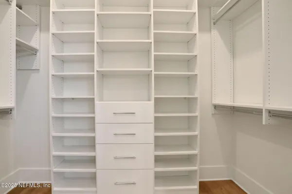 a view of a balcony with wooden floor and a ocean view
