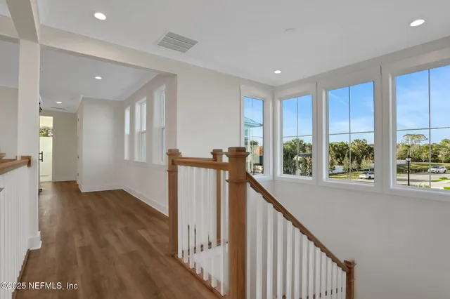 a living room with furniture a fireplace and a floor to ceiling window
