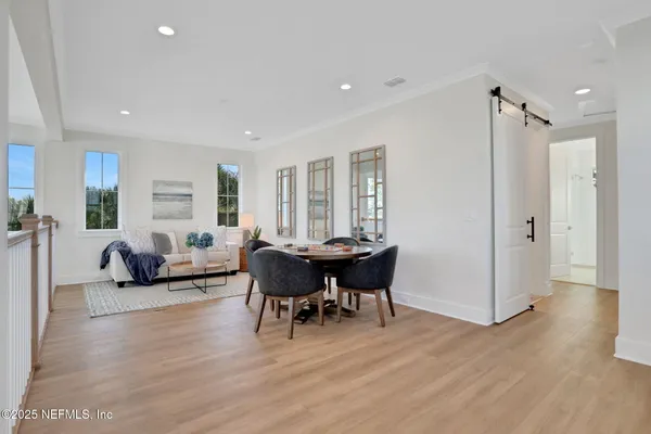 a living room with furniture a fireplace and a floor to ceiling window