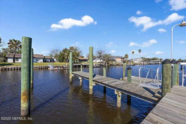 a kitchen with white cabinets a stove and a window