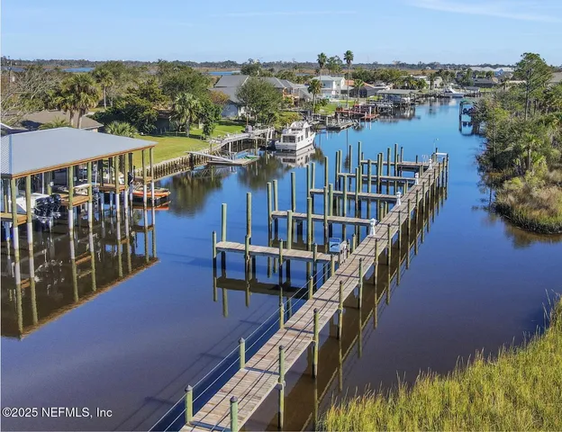 a kitchen with a table chairs sink and cabinets