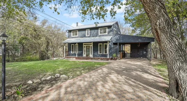 a view of a house with a yard and plants