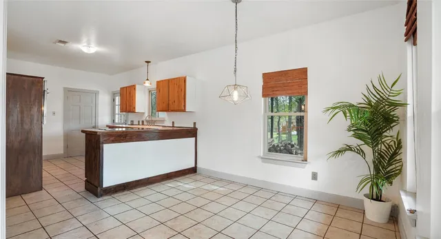 a kitchen with a refrigerator and a sink