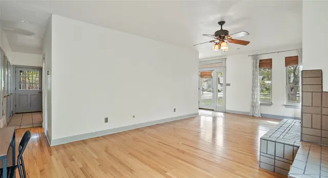 wooden floor in an empty room with a window