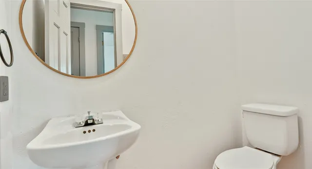 a bathroom with a toilet and a sink