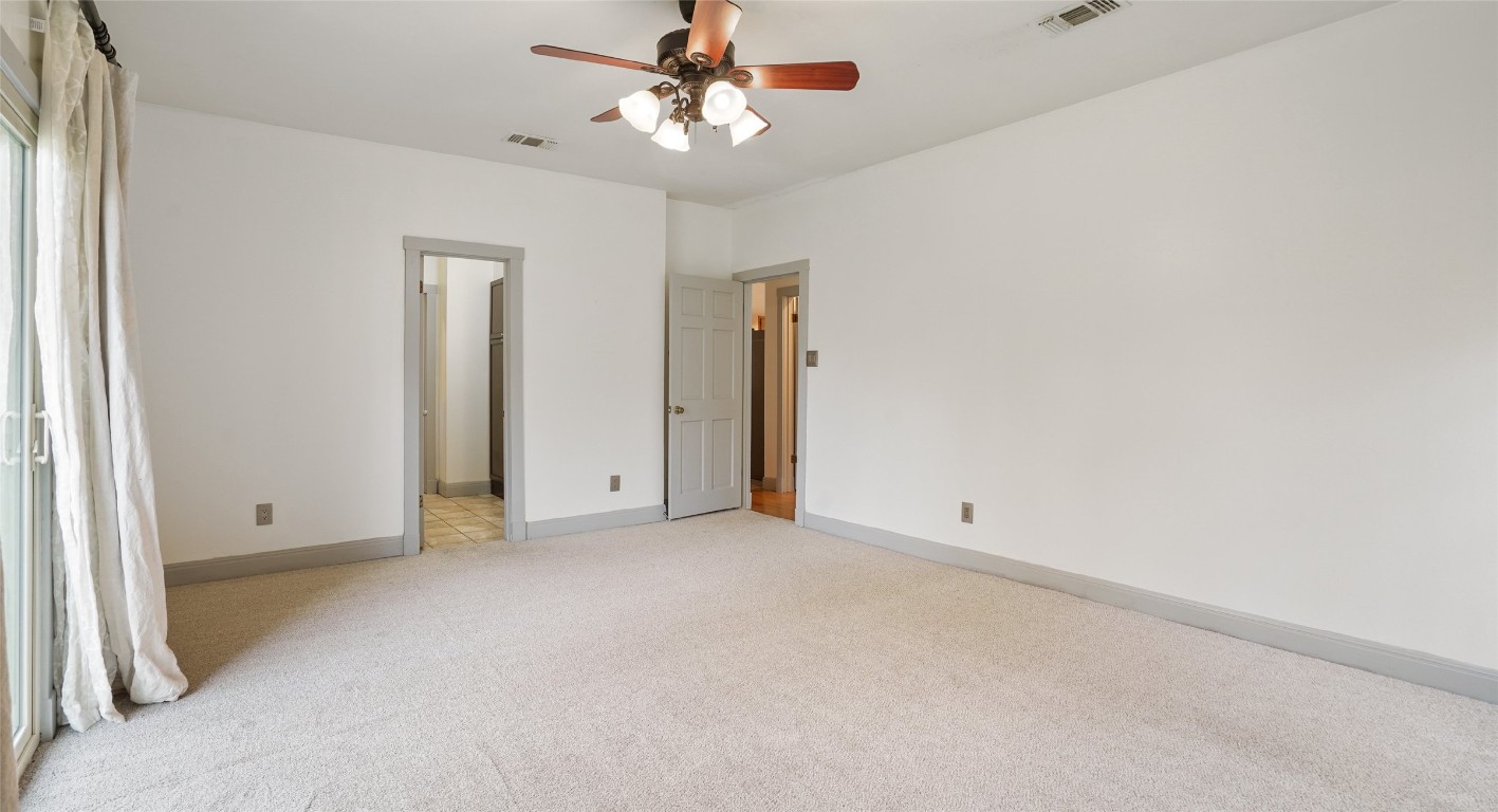 13918 Hummingbird Lane Austin, TX 78732 - Photo 20 of 36 an empty room with a ceiling fan and a window