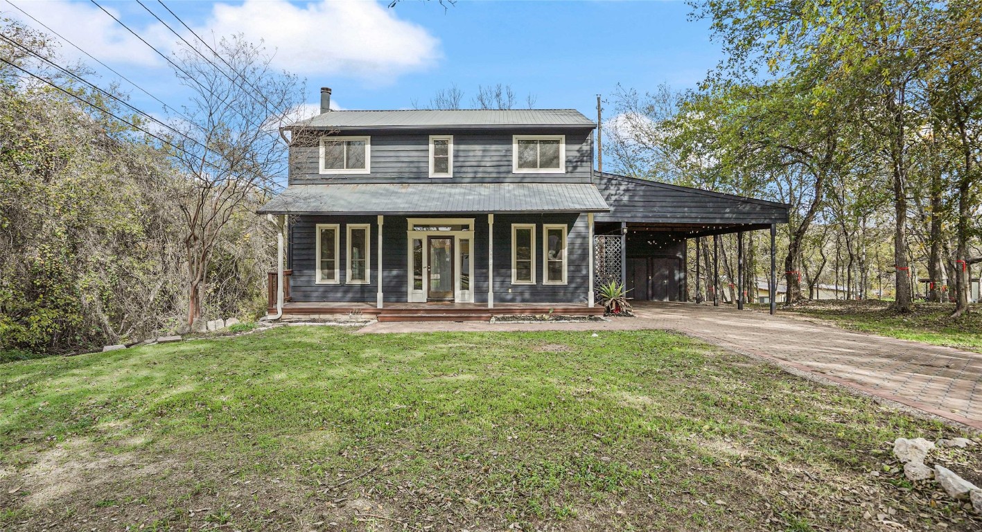 13918 Hummingbird Lane Austin, TX 78732 - Photo 2 of 36 a front view of a house with a yard