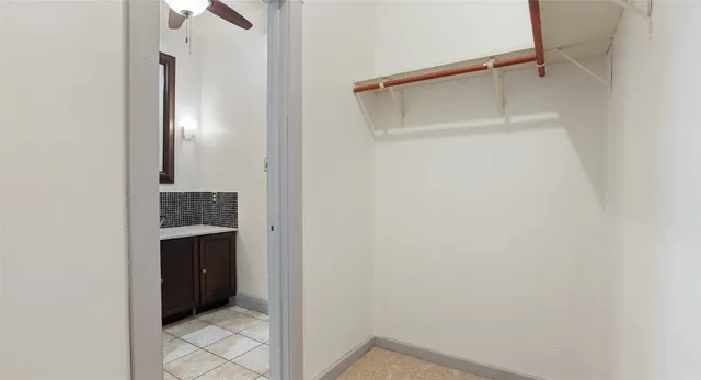 a bathroom with a walk in closet and a bathroom