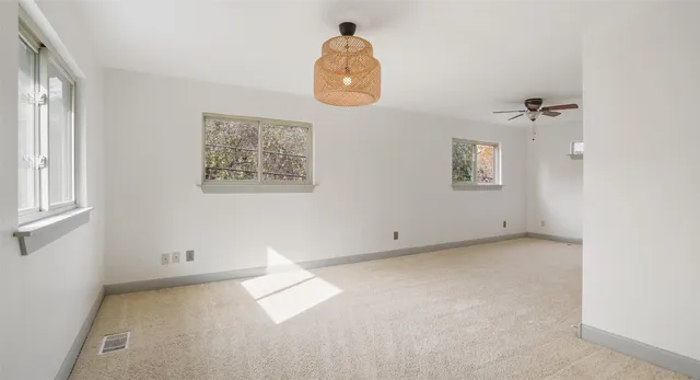 an empty room with windows and closet