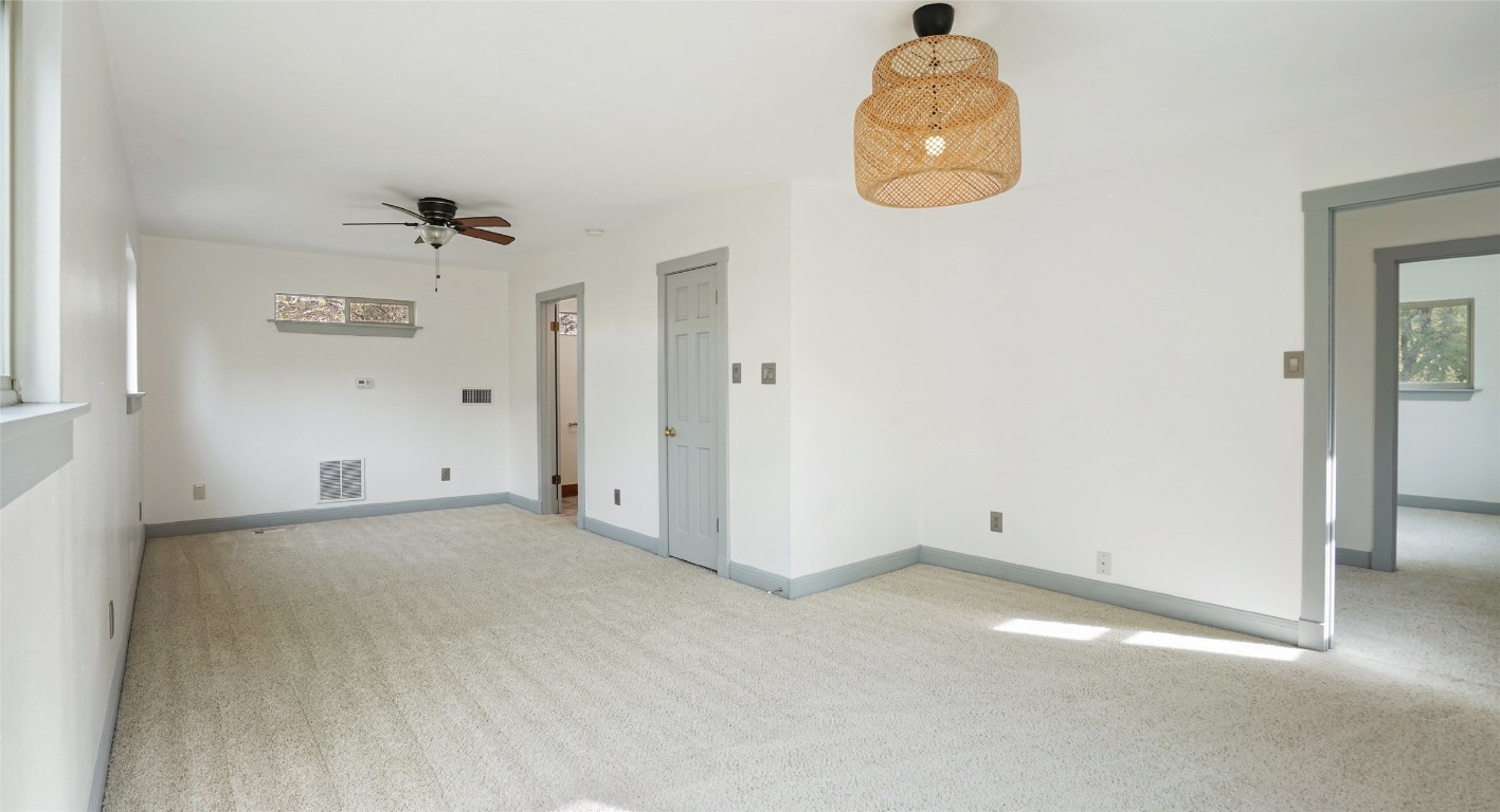 13918 Hummingbird Lane Austin, TX 78732 - Photo 28 of 36 an empty room with a fan and mirror