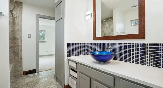 a bathroom with a sink and a mirror