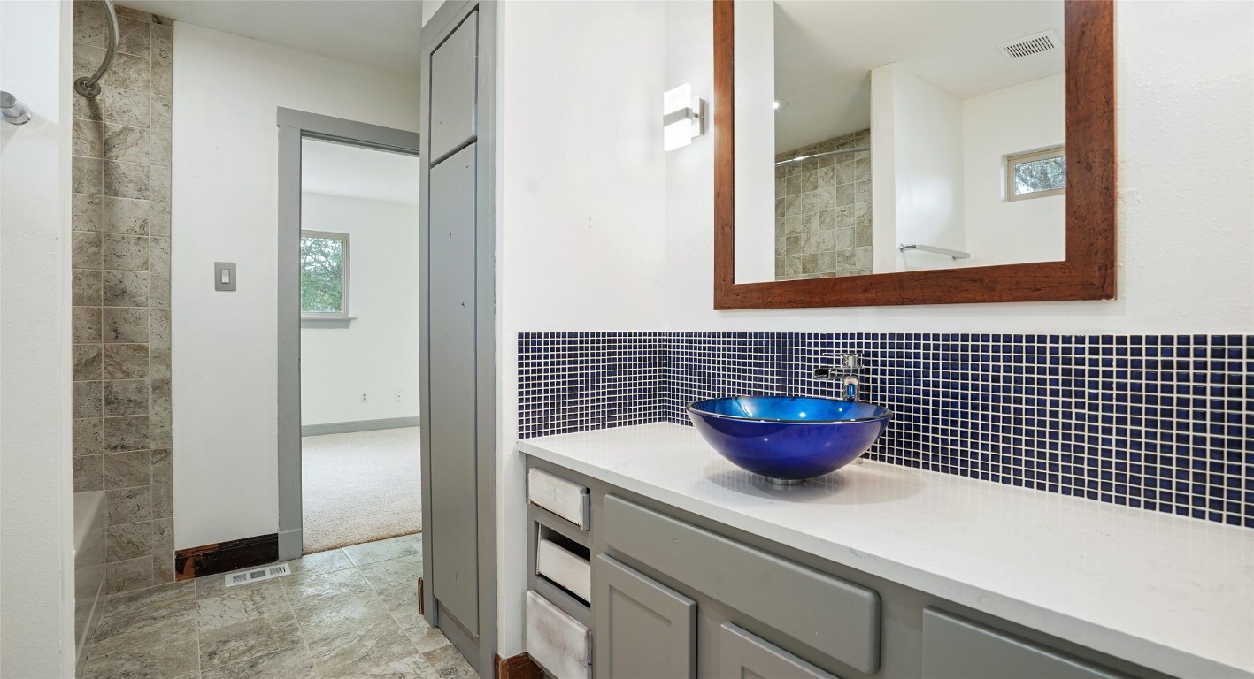 13918 Hummingbird Lane Austin, TX 78732 - Photo 31 of 36 a bathroom with a sink and a mirror