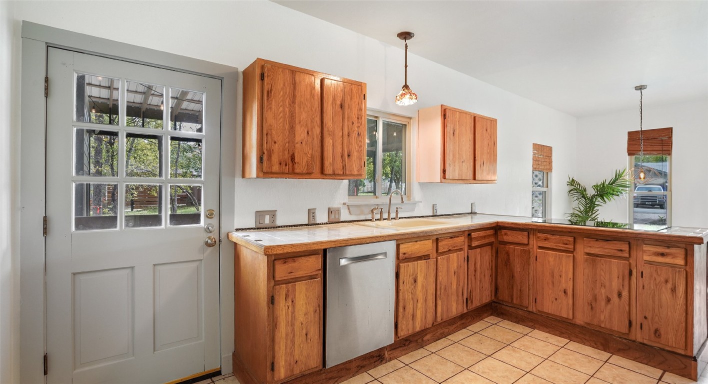 13918 Hummingbird Lane Austin, TX 78732 - Photo 6 of 36 a kitchen with a sink window and cabinets