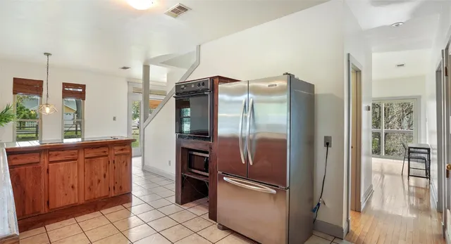 a kitchen with stainless steel appliances granite countertop a refrigerator and a sink
