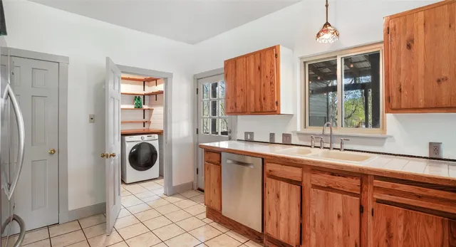 a kitchen with a refrigerator and window