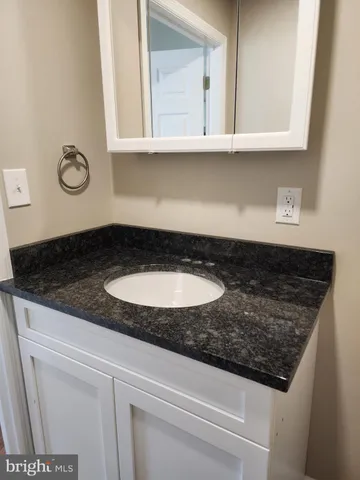 a kitchen with granite countertop a sink and a stove