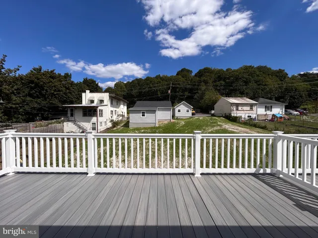 a view of a balcony with wooden floor and city view